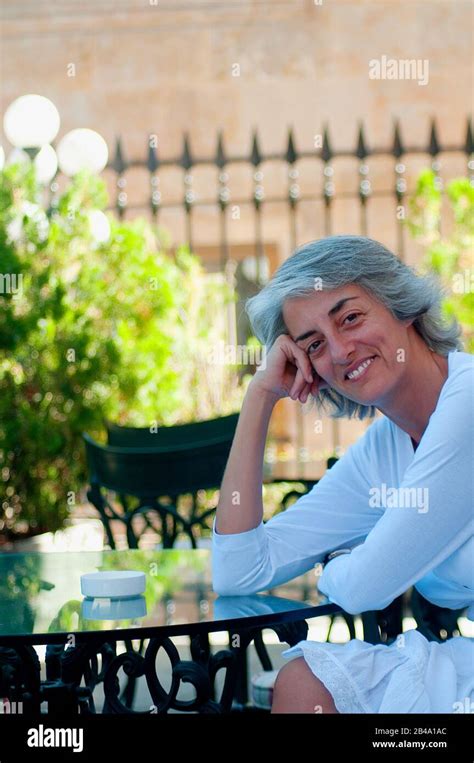 Portrait Of Mature Woman Sitting On A Terrace Stock Photo Alamy