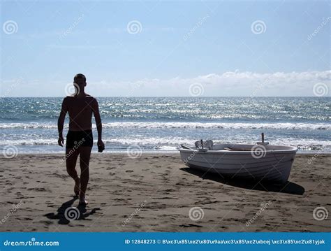 Silhouette Of Young Man Walking On A Beach Stock Photos - Image: 12848273