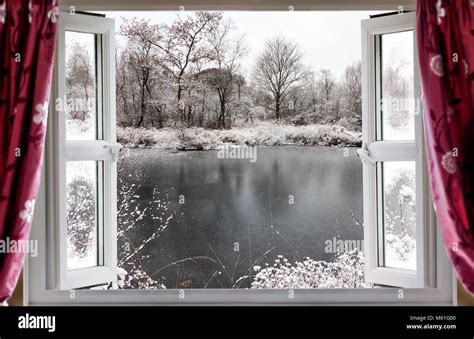 View Through Open Window Onto A Beautiful Frozen Lake Winter Snow In