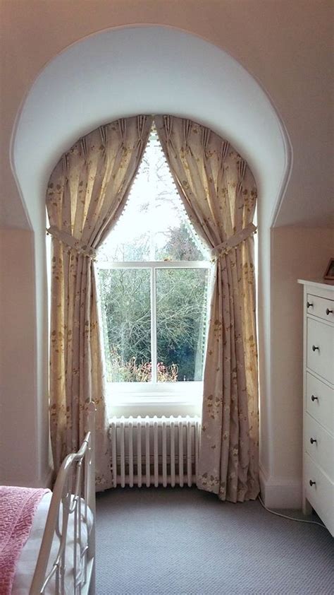 A Bedroom With A Bed Dresser And Window Overlooking The Garden Outside