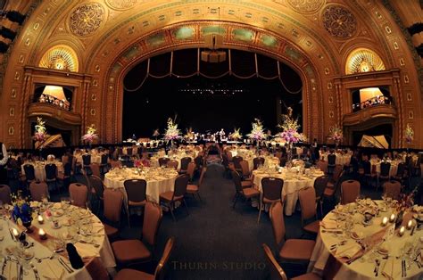 an ornately decorated ballroom with tables and chairs