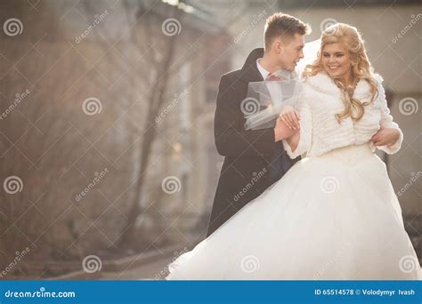 Happy Newlywed Groom Hugging Blonde Beautiful Bride From Behind Stock
