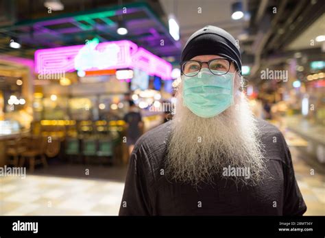 Mature Bearded Hipster Man Thinking With Mask For Protection From