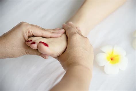 Woman Receiving Foot Massage Service From Masseuse Close Up At Hand And Foot Relax In Foot