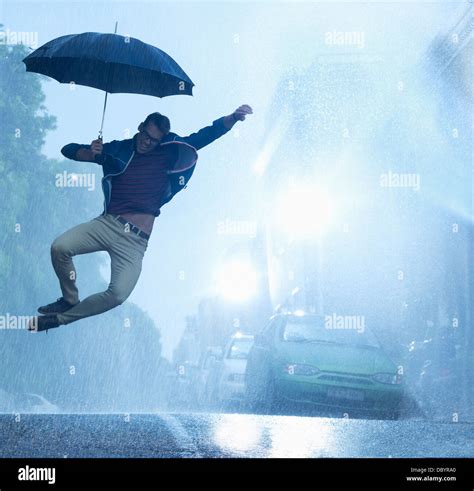 Man Holding Umbrella In Rain Hi Res Stock Photography And Images Alamy