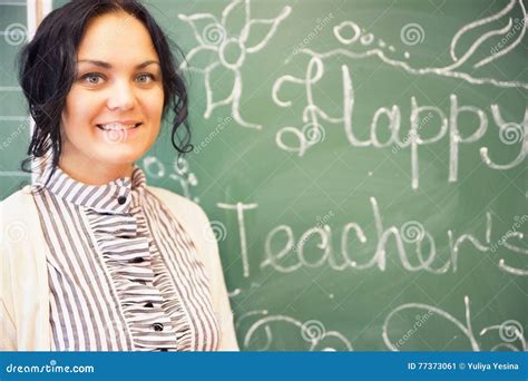 Portrait Of Young Happy Smiling Teacher Woman Standing Near Chal Stock