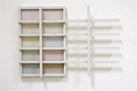 A White Shelf With Several Different Colored Shelves On It S Sides