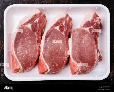 Raw Fresh Uncooked Pork Meat Chop Steak On Bone In White Container