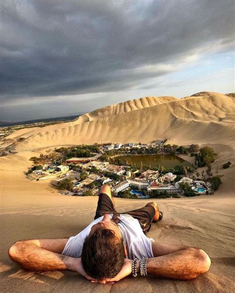 A Man Laying In The Sand On Top Of A Beach