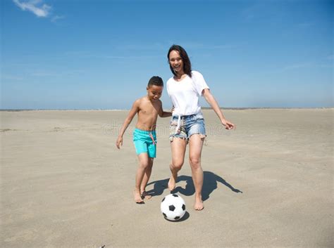 Moder Och Son Som Spelar Fotboll På Stranden Arkivfoto Bild Av