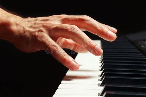 Hand Of Pianist Play The Keys Of The Digital Piano On Black Background