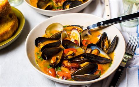 Mussels And Clams In A Spicy Tomato Broth With Bacon Tomato Broth Recipes Mussels