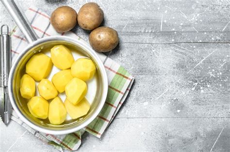 Premium Photo Peeled Potatoes In A Saucepan On Napkin