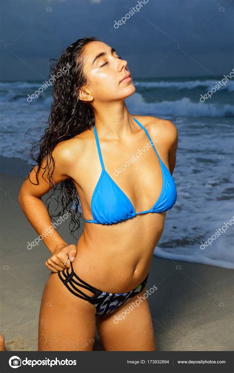 Woman In A Bikini Posing On The Beach With Eyes Closed Stock Photo