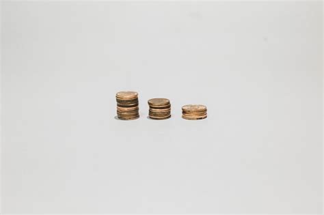 Premium Photo Stack Of Coins Against White Background