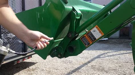 Looking At The Coolant Container Of The 1025r John Deere Tractor And