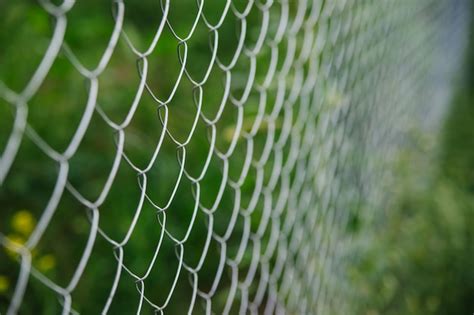 Premium Photo The Background Is Made Of Metal Mesh A Fence On A