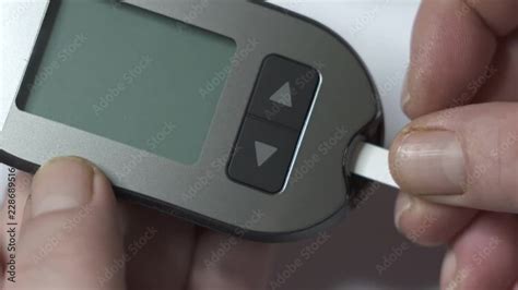 Patient With Diabetes Using Blood Glucose Meter To Test Blood Glucose