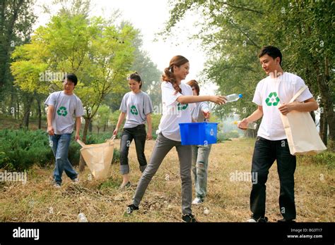 Young People Collecting Empty Plastic Bottles For Recycling Stock Photo