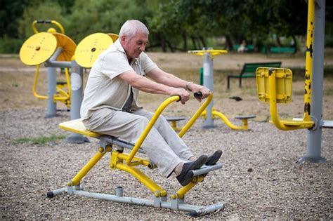 Premium Photo | Old man making exercises on outdoor gym