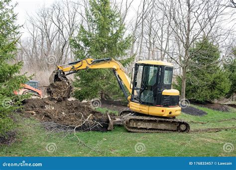 Backhoe Digging Soil At Construction Site. Bucket Of Backhoe Digging Soil. Clearing And Grubbing ...