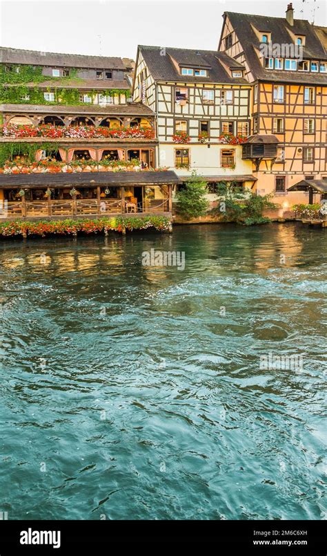 Traditional Half Timbered Houses On The Banks Of River Ill Stock Photo