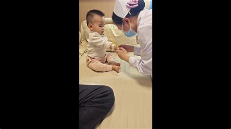 Calm baby remains unfazed while receiving injection