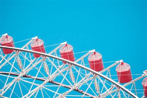 Premium Photo Low Angle View Of Ferris Wheel Against Clear Blue Sky