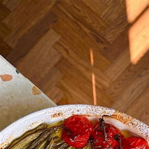 A White Bowl Filled With Vegetables On Top Of A Wooden Table