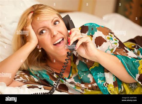 Beautiful Blonde Woman Laying On Her Bed Using The Telephone Stock Photo Alamy