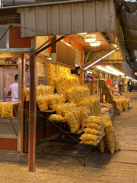 A Seller Of Potato Chips On The Sidewalk And The Presence Of Other