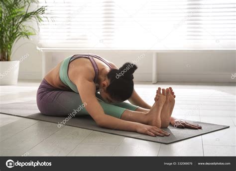 Woman Practicing Seated Forward Bend Asana Yoga Studio