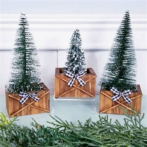 Three Wooden Boxes With Christmas Trees In Them