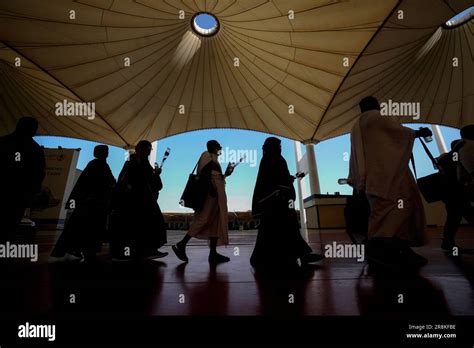 Pilgrims Walk Under Giant Umbrellas At The Hajj Terminal Of King