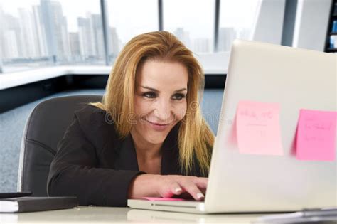 Relaxed 40s Woman With Blond Hair Smiling Confident Sitting On Office