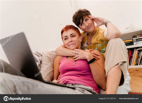 Mature Lesbian Couple Hugging Using Laptop Sofa Home Stock Photo By Vadymvdrobot