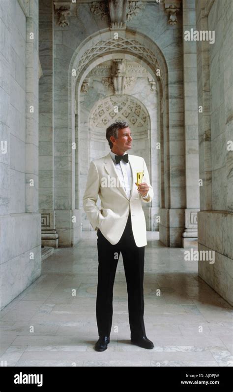 Wealthy Aristocratic Millionaire In White Tuxedo Holding A Champagne