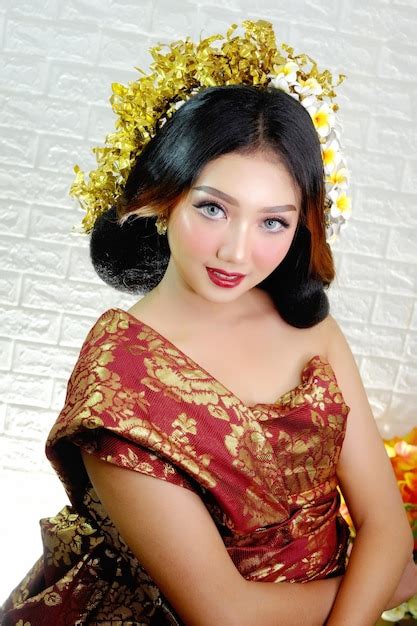 Premium Photo A Woman In A Red Dress With Yellow Flowers On Her Head