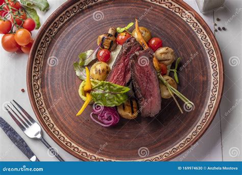 Filet Mignon Served With Grilled Vegetables And Mushrooms Restaurant