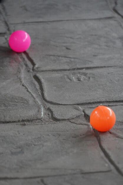 Premium Photo | Colorful balls on the concrete floor