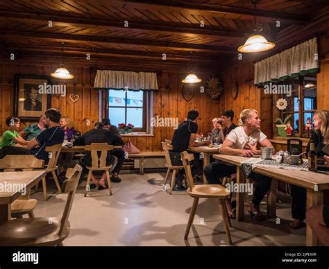 The Image Is Of Groups Of People Relaxing At The Franz Senn Hut In The