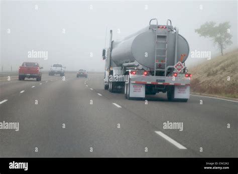 Tanker Truck Driving In Fog On Highway Near Denver Colorado Usa Stock