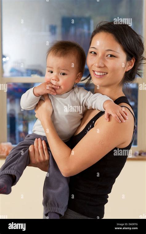 Smiling Korean Mother Holding Baby Stock Photo Alamy