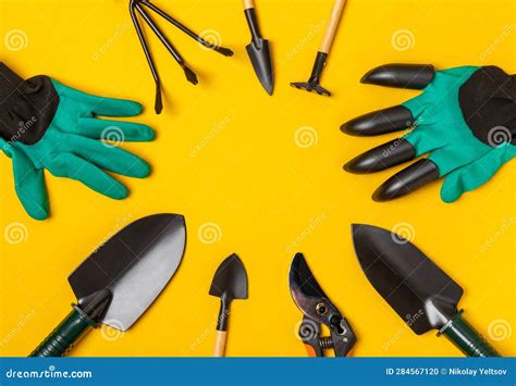 Gardening Tools Pruner Gardening Gloves Shovel And Rake On A Bright