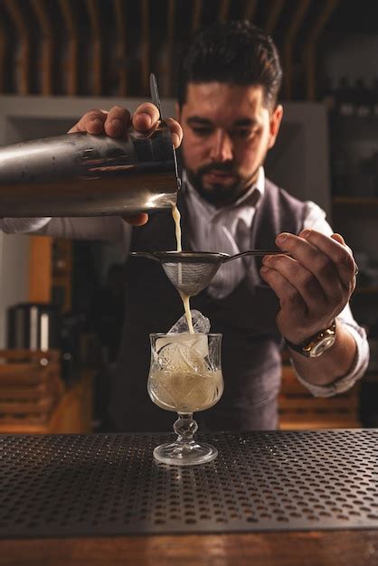 Premium Photo | Expert bartender crafting a cocktail