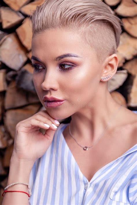 Closeup Portrait Blonde Model With Bright Make Up And Short Hair With Shaved Temples In A Modern