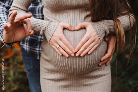 Heart Of Hands By Multiethnic Couple On Pregnant Belly Man Holding Belly Of His Pregnant Wife