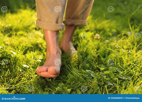 Woman Walking Barefoot on Green Grass Outdoors, Closeup Stock Image