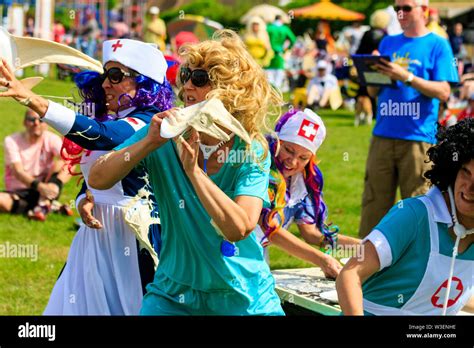 World Custard Pie Championship. Young women team dressed as nurses with ...