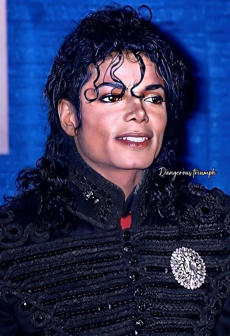 michael jackson is dressed in black and has his hair pulled back with ...